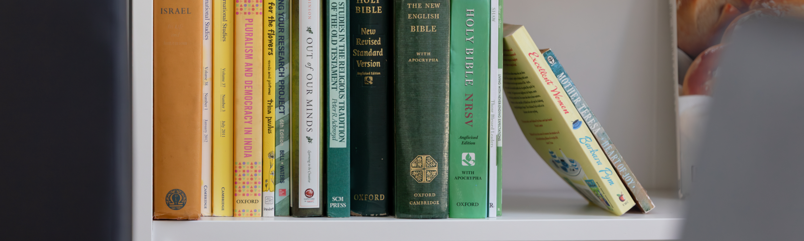 Historic books on modern white shelf