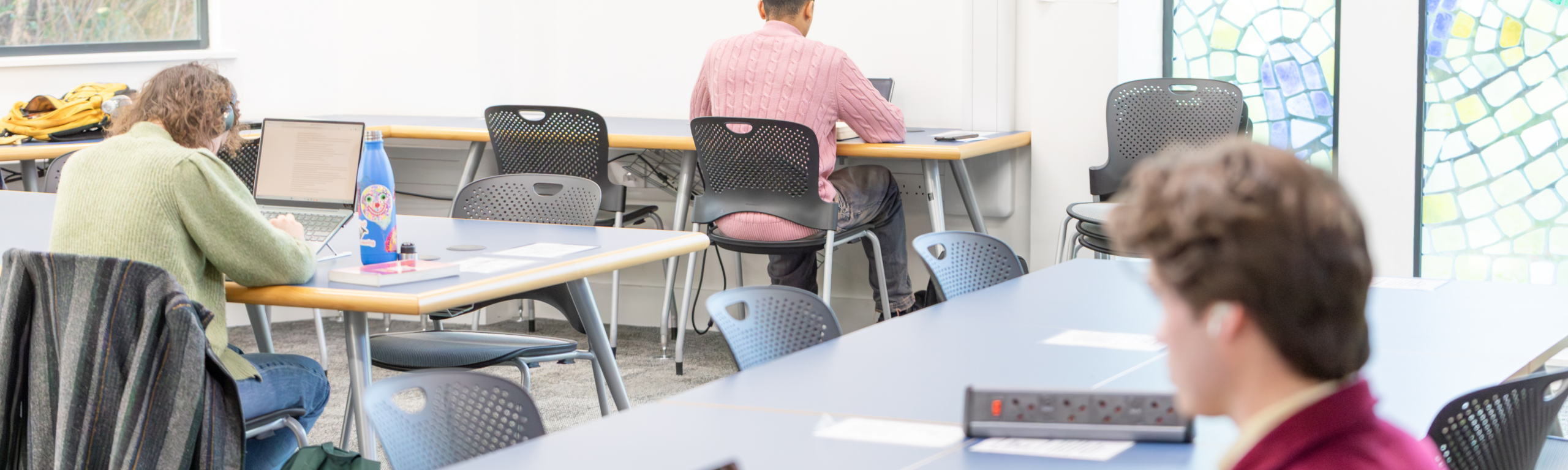 students work in airy library space